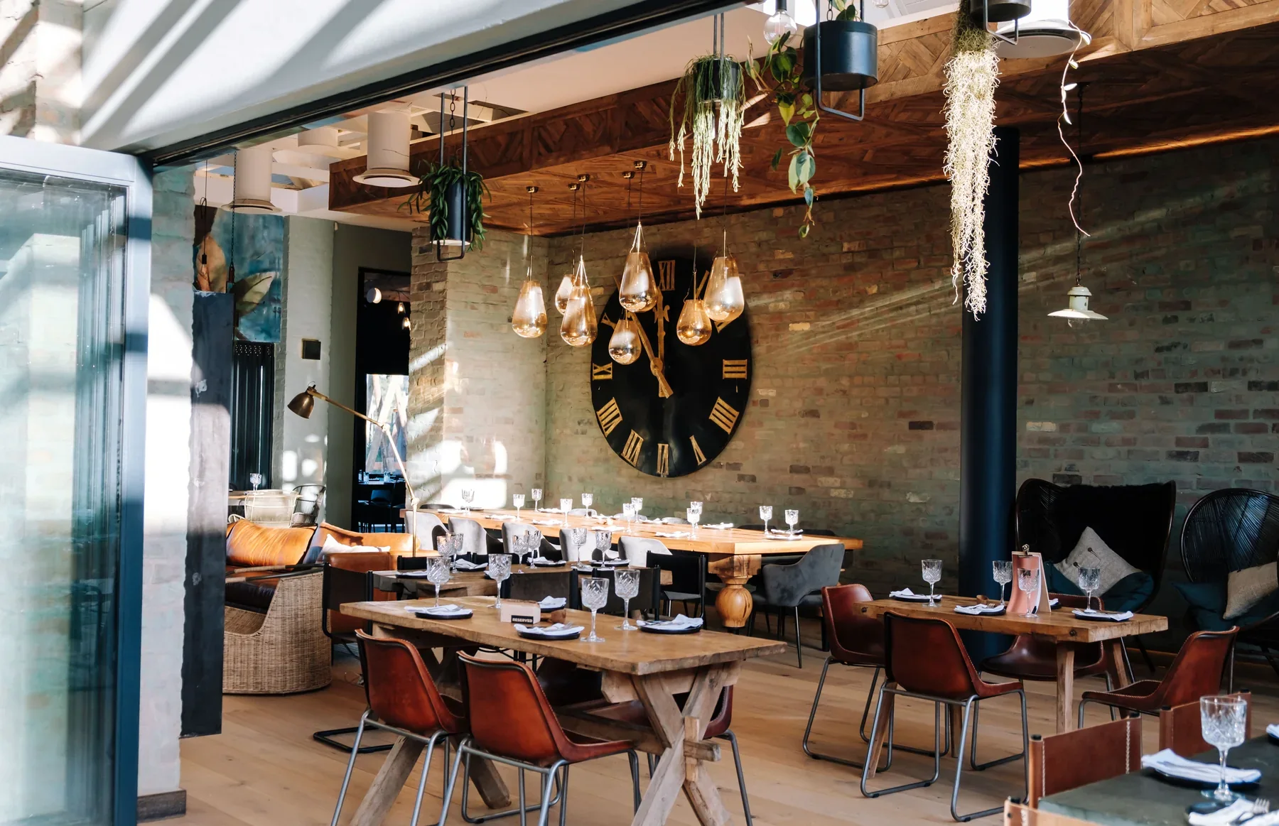 45 on Eat Street interior with a sculptural clock, bespoke table and pendant lighting by Country Kitchens