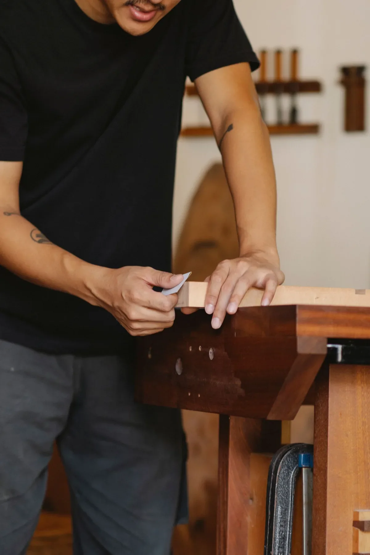 Craftsperson finishing timber, used as temporary reference photography